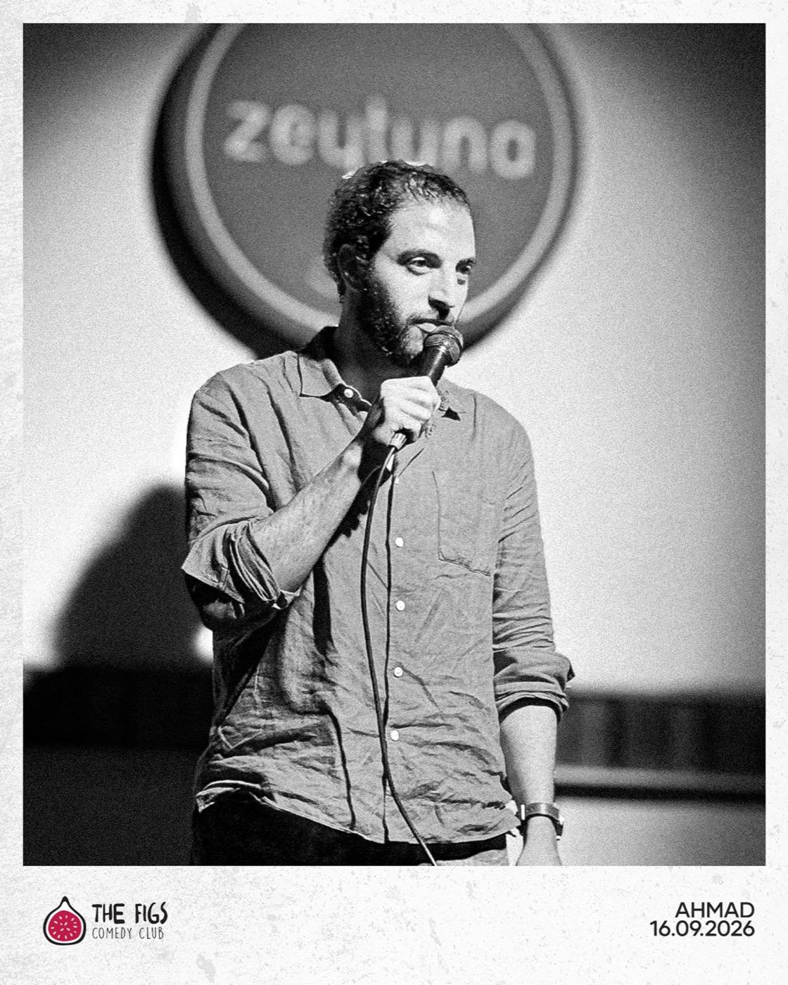 Ahmad holding a microphone on stage