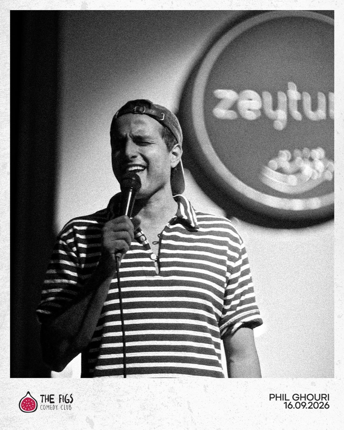 Phil Ghouri performing in a striped polo