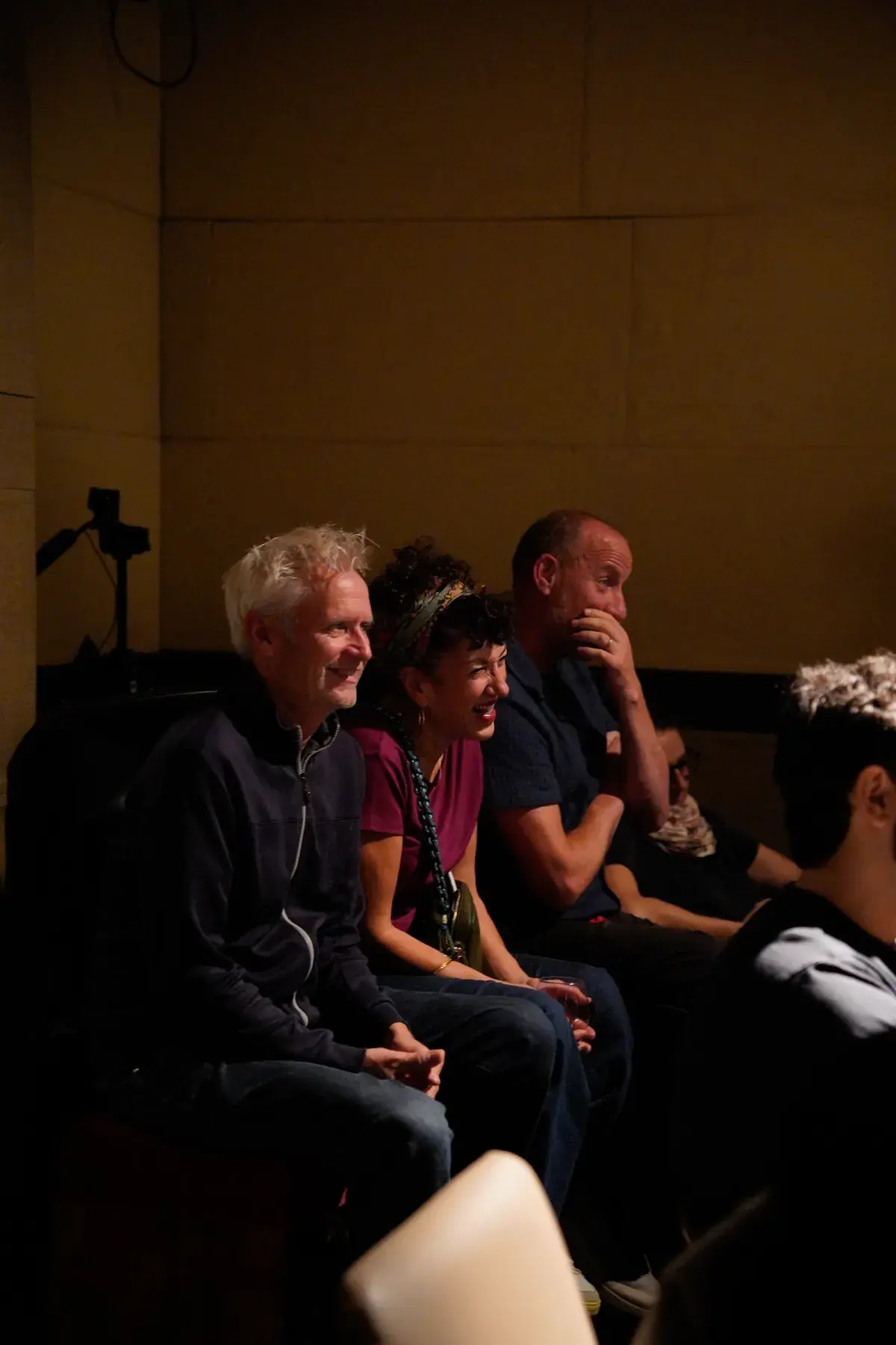 Front-row audience members laughing