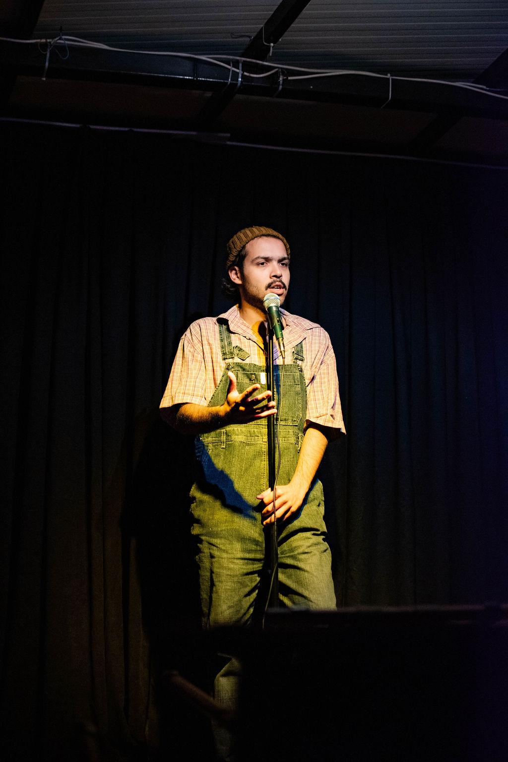 Selah Ucla performing in overalls and a beanie